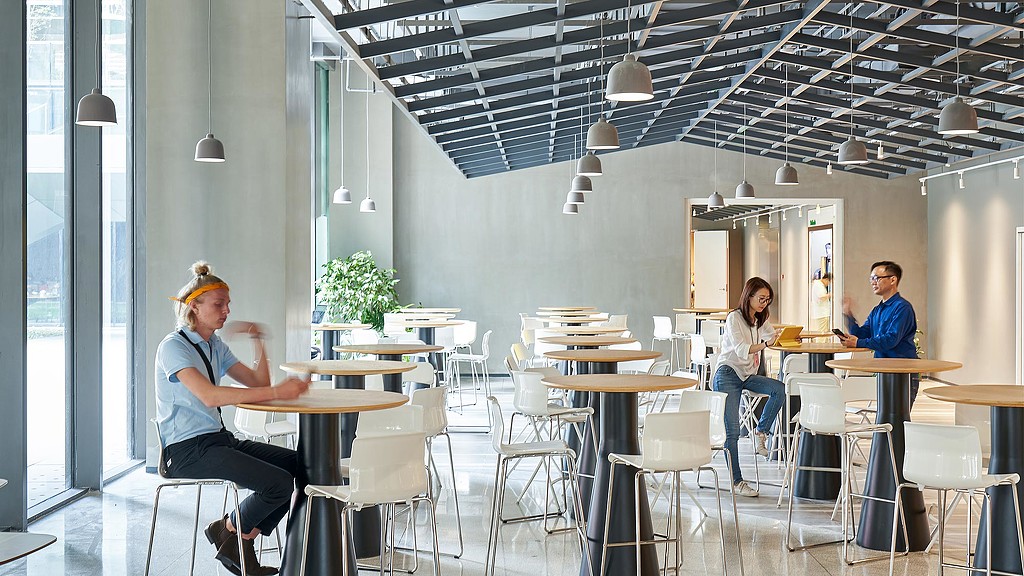 A group of people sitting at tables.